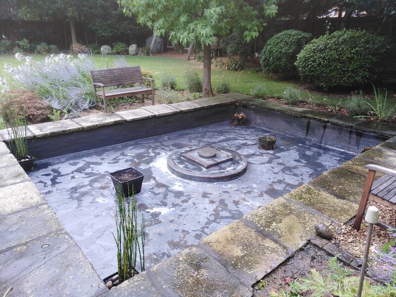 Drained and freshly cleaned slab rimmed square pond