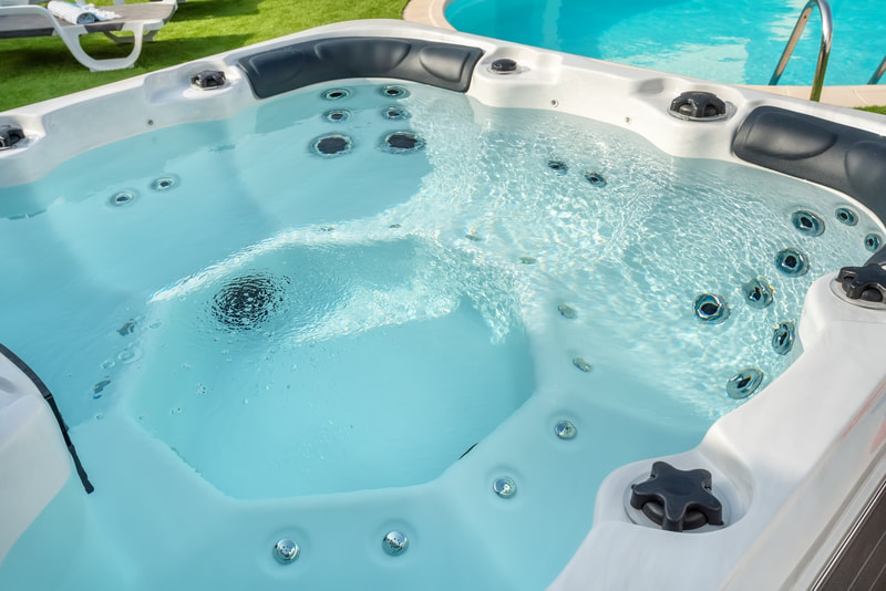 Lay-z-spa hot tub next to pool in back garden