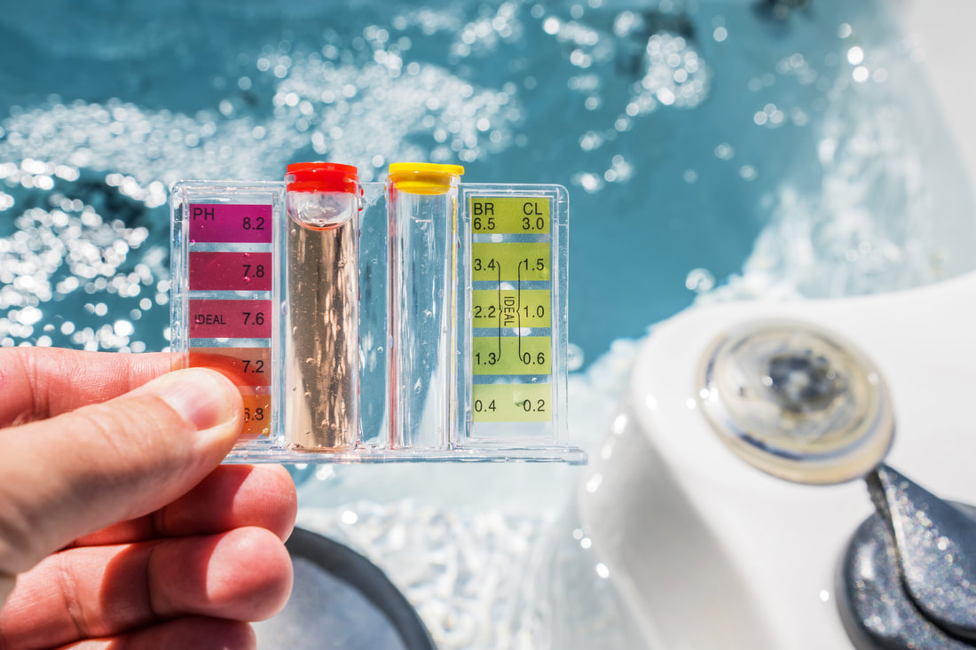 Technician testing hot tub water parameters